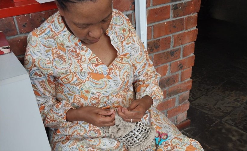 Artisan Ivy Nhlapo crafting recycled pull-tab bags in her Langa township workshop
